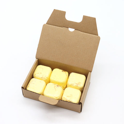 Open box of six Focus Booster shower steamers, pale yellow