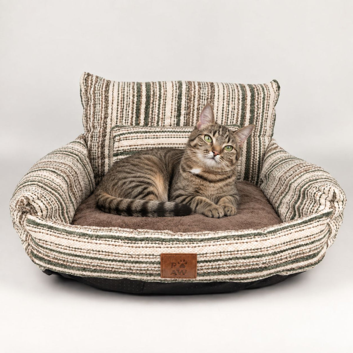 Tabby cat sitting in the striped sofa pet bed