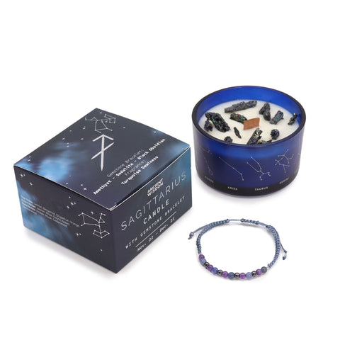 Sagittarius candle and closed gift box standing together with the gemstone bracelet in front