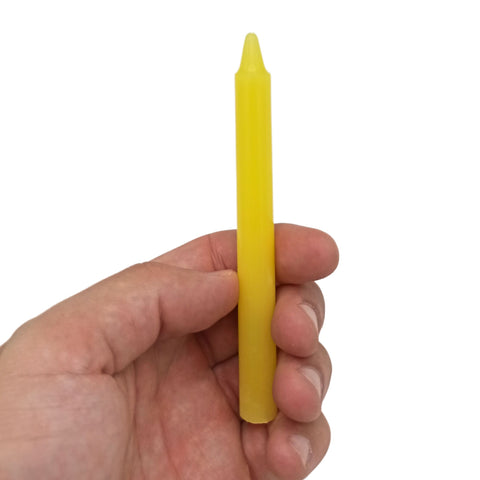 Yellow Solar Plexus Chakra candle held in a hand