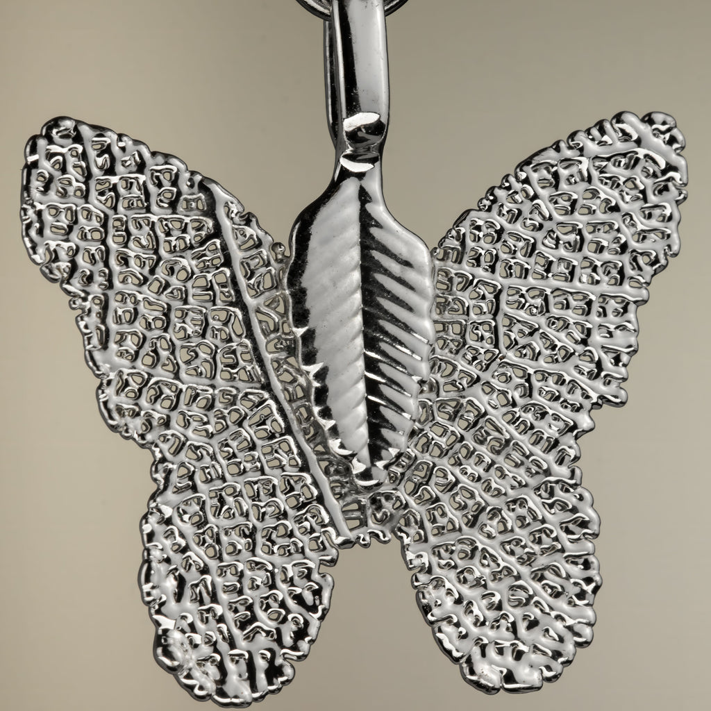 Close-up of the silver-coloured butterfly charm