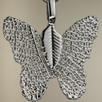 Close-up of the silver-coloured butterfly charm
