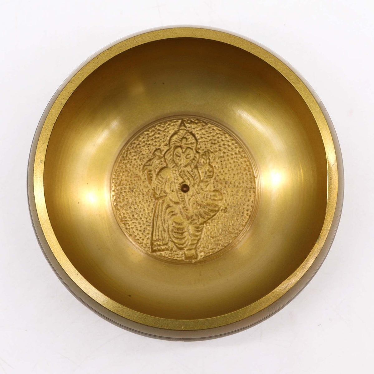Ganesh Singing Bowl, top view showing a gold interior and an embossed Ganesh design at the centre