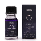 Libra zodiac fragrance oil bottle in dark purple glass next to its star-sign gift box