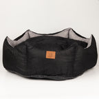 Black crown-shaped pet bed viewed from the front