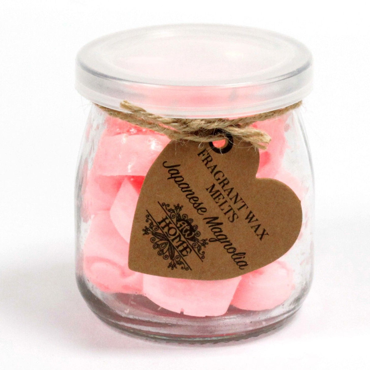 Closed glass jar of pink Japanese Magnolia melts, with a heart-shaped kraft label tied at the neck