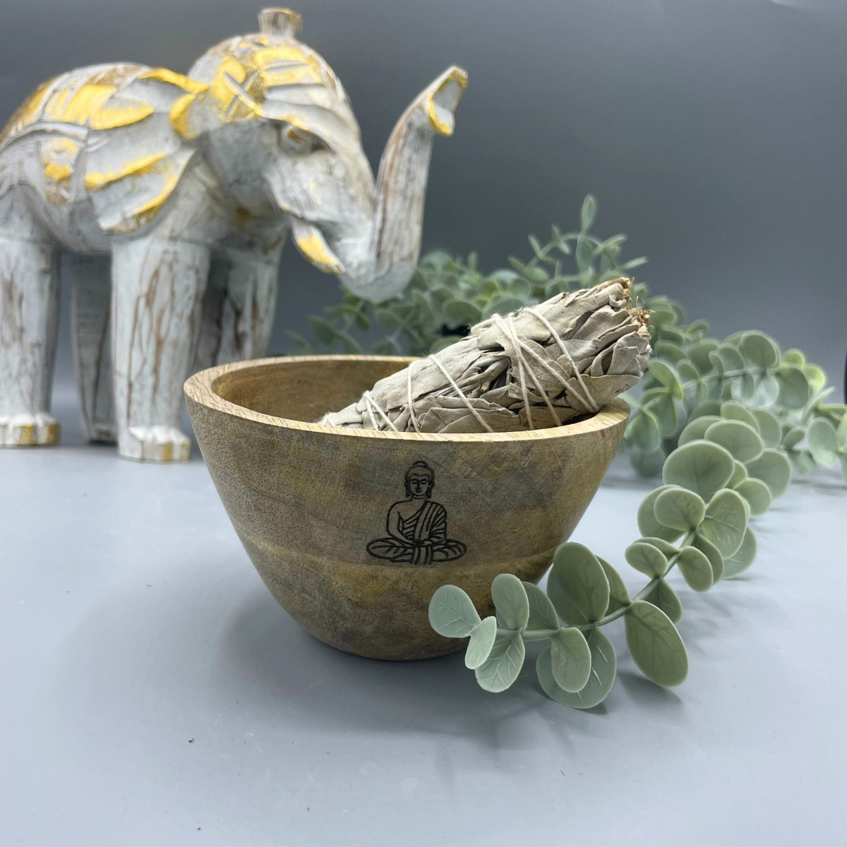 Wooden Smudge and Ritual Offerings Bowl, Buddha, with a sage bundle, greenery and a decorative elephant