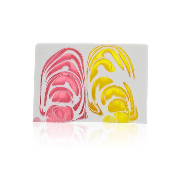 Orchid soap slice shown close up from the front, with bold pink and yellow swirls on white