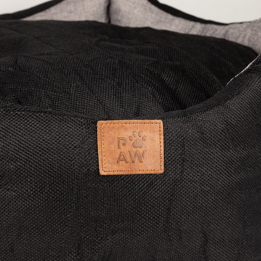 Close view of the PAW label on the bed
