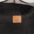 Close view of the PAW label on the bed
