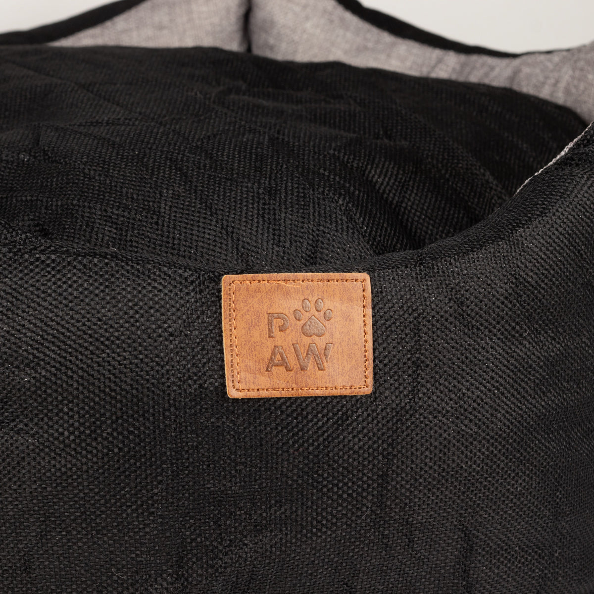 Close view of the PAW label on the bed