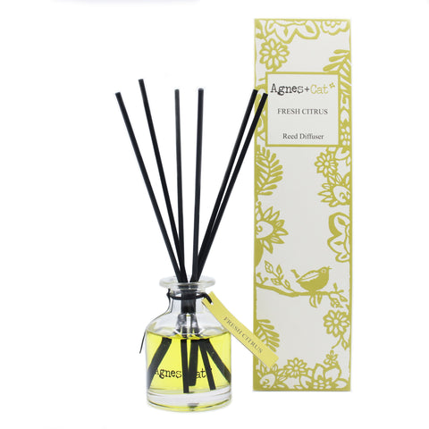 140ml Reed Diffuser, Fresh Citrus in a clear glass bottle with black reeds beside its yellow floral box