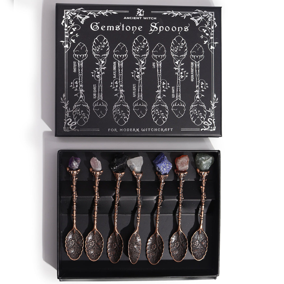 Set of 7 Bronze Gemstone Crystal Witch Spoons displayed in an open black illustrated box