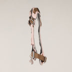 Side view showing the harness straps and charm