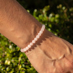 Petite rose quartz bracelet worn around a wrist
