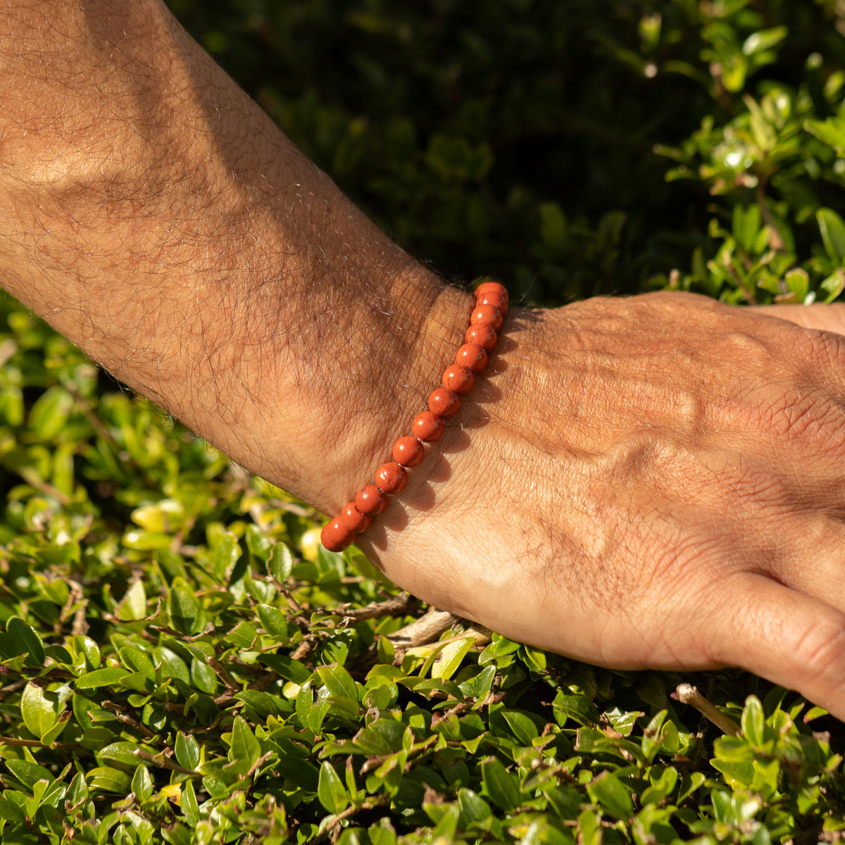 Carnelian bracelet worn on a wrist outdoors