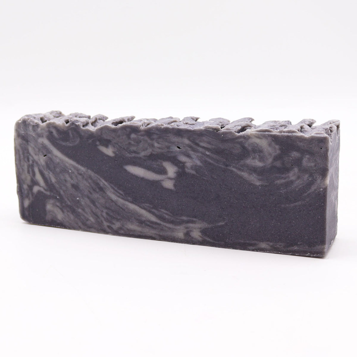 Dead Sea Mud, Olive Oil Soap Loaf, a single long dark grey bar with pale swirls on white