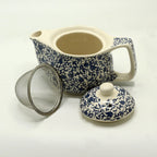 Small herbal teapot shown with its lid and metal strainer removed