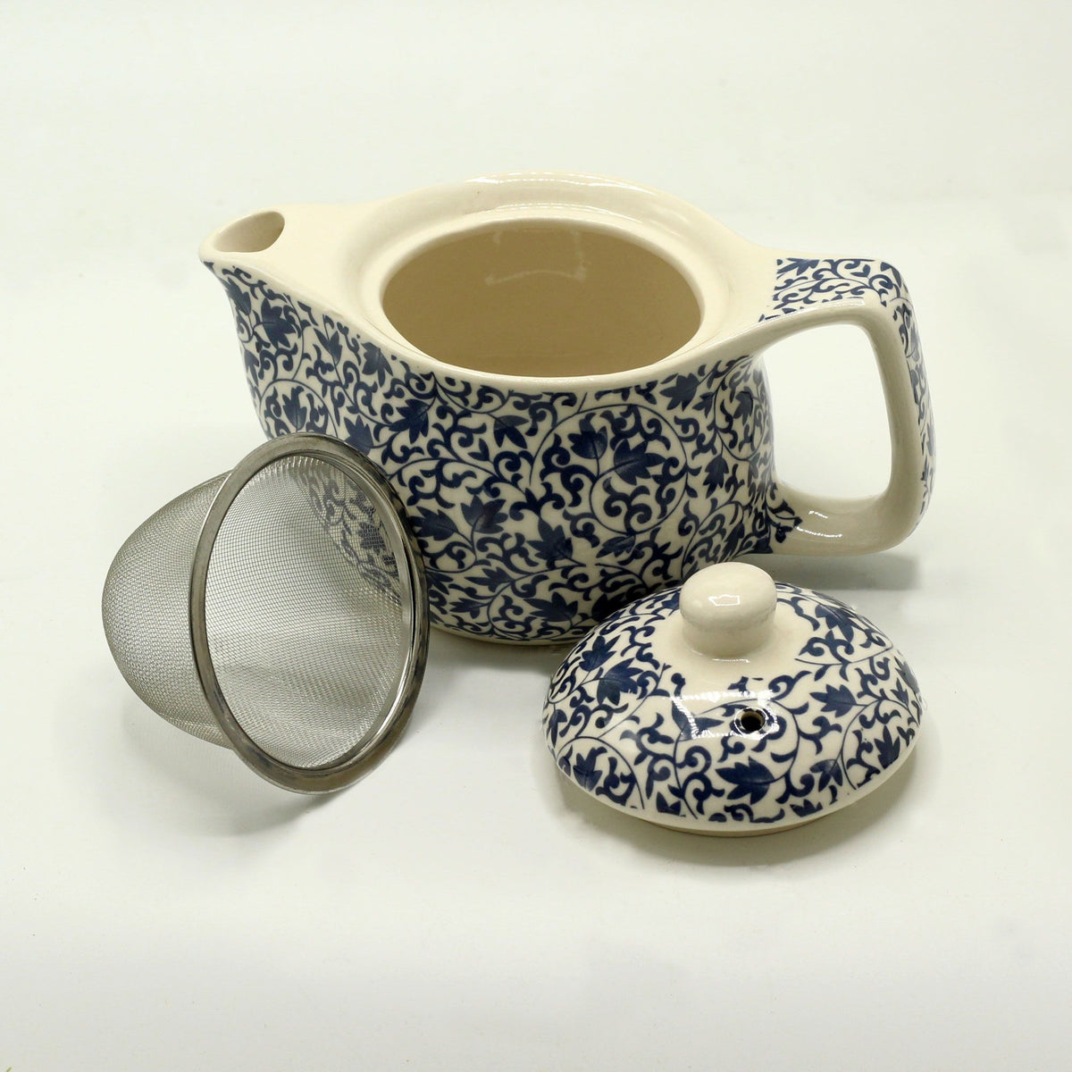 Small herbal teapot shown with its lid and metal strainer removed