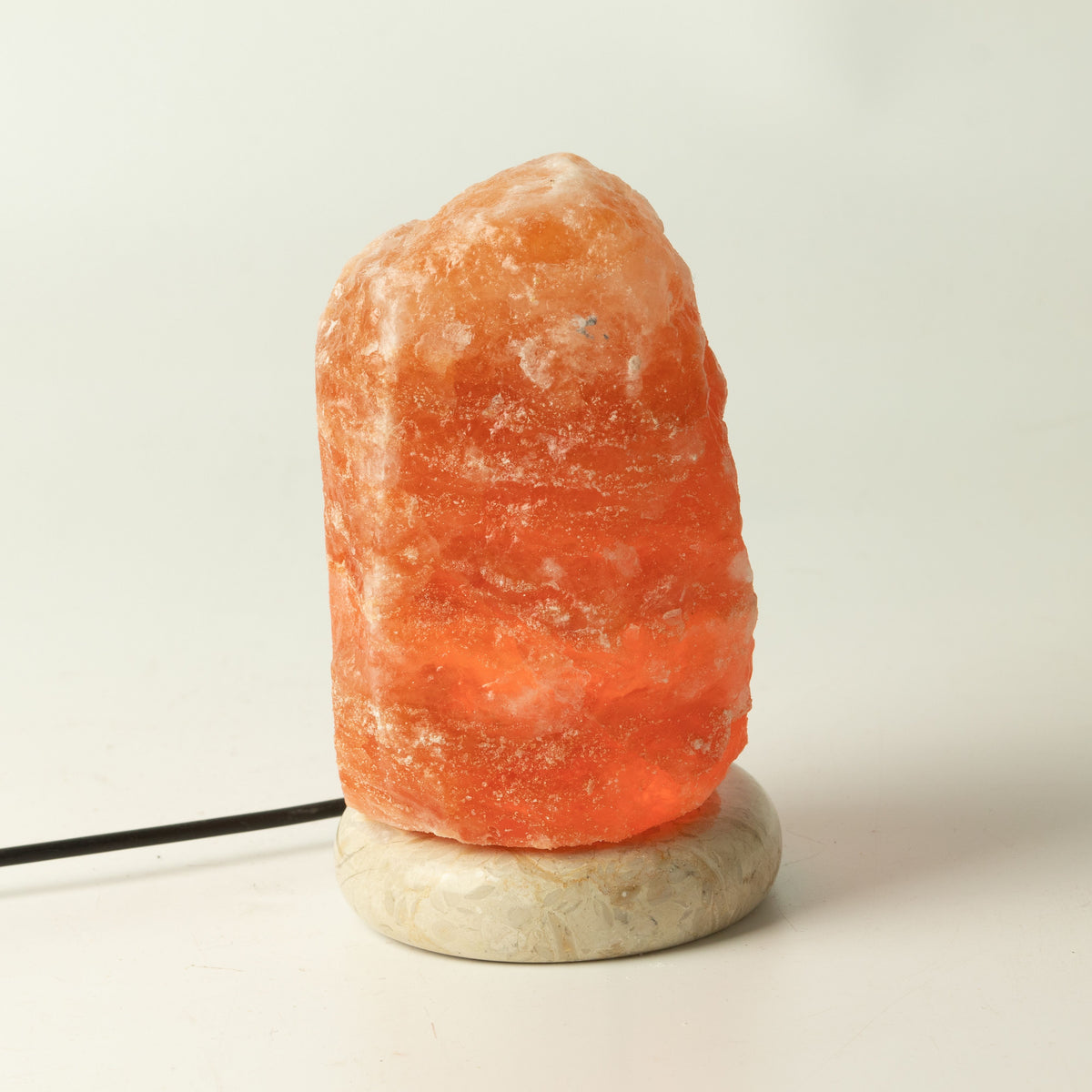 Quality USB Natural Salt Lamp, orange salt rock on a pale round base with its black cable
