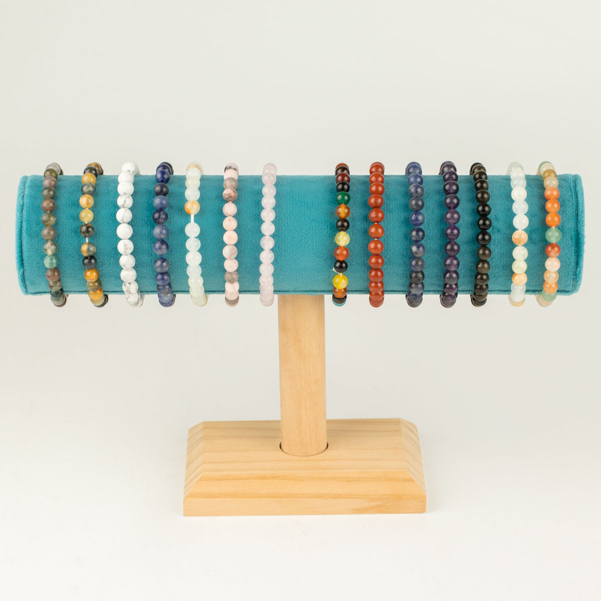 A row of assorted beaded bracelets on a display stand