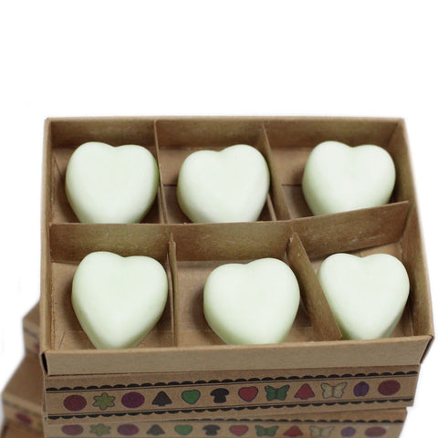 Apple Spice wax melts shown close up, six pale heart shapes arranged in the open decorated box