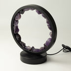 Angled view of the unlit lamp, showing the stones and black frame