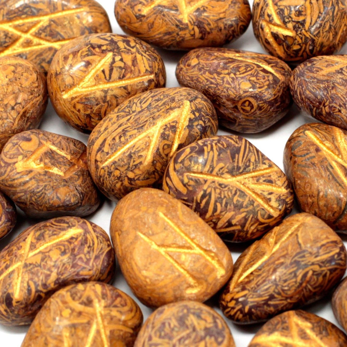 Runes Stone Set in Pouch, Snake Jasper, close-up of orange-brown stones with dark patterns and carved symbols
