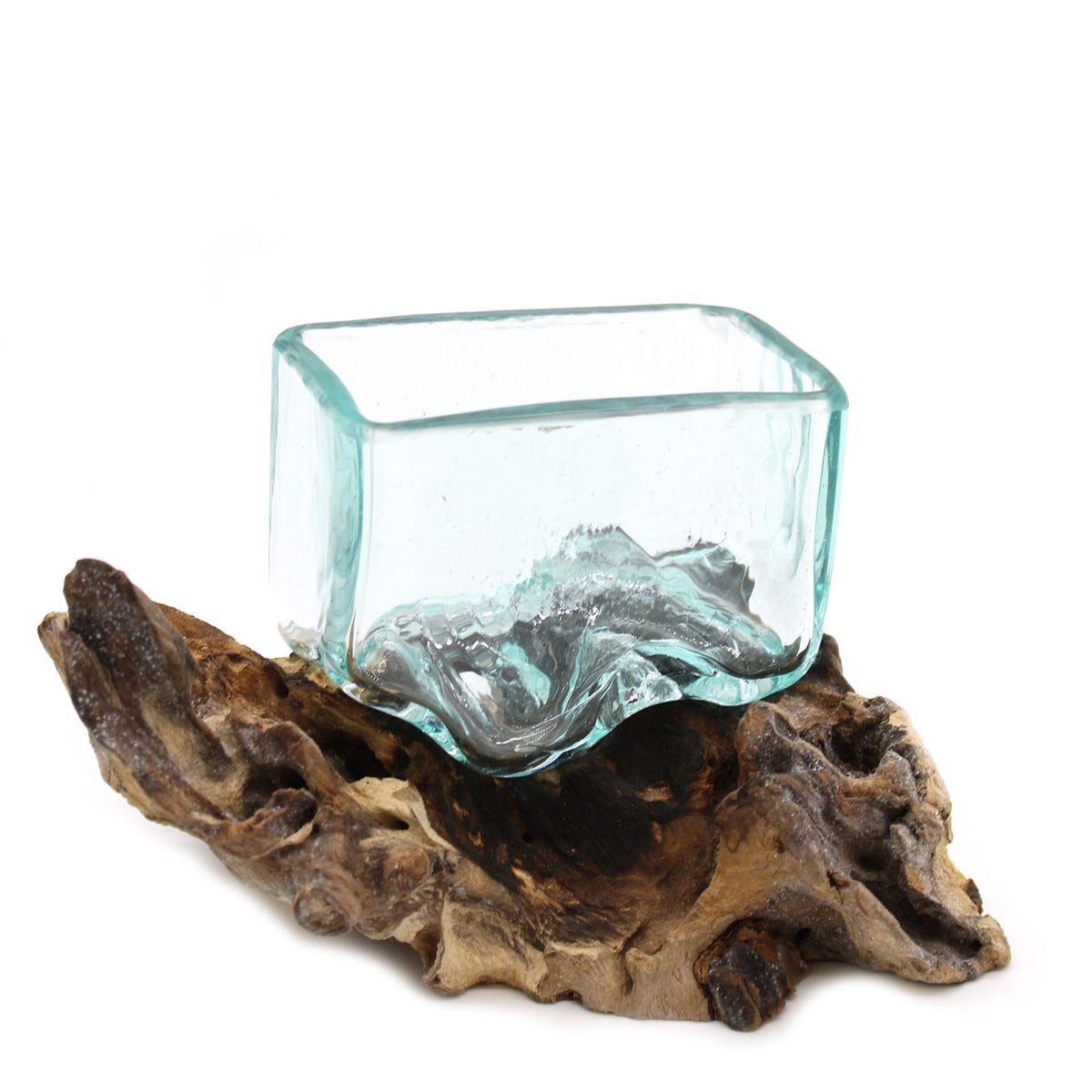 Molten glass bowl in a close-up view, clear aqua glass resting on a piece of textured wood