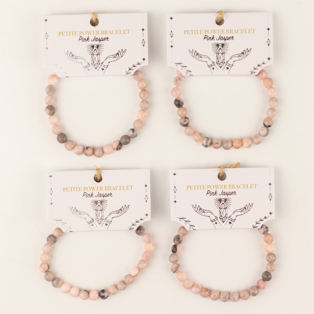 Four Pink Jasper bracelets on illustrated cards
