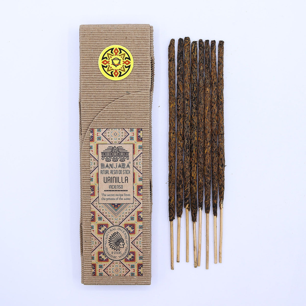 Ritual Resin on Stick, Vanilla in a patterned cardboard sleeve beside dark resin-coated sticks