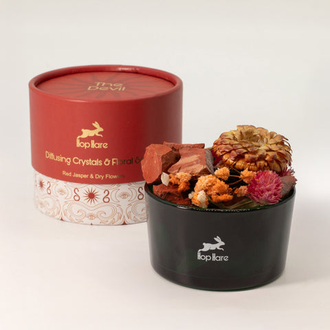 Red jasper and dried flower vessel beside its rust-red box