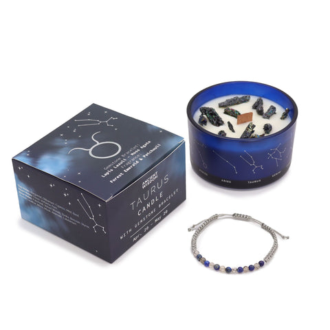 Taurus candle and closed gift box standing together with the gemstone bracelet in front