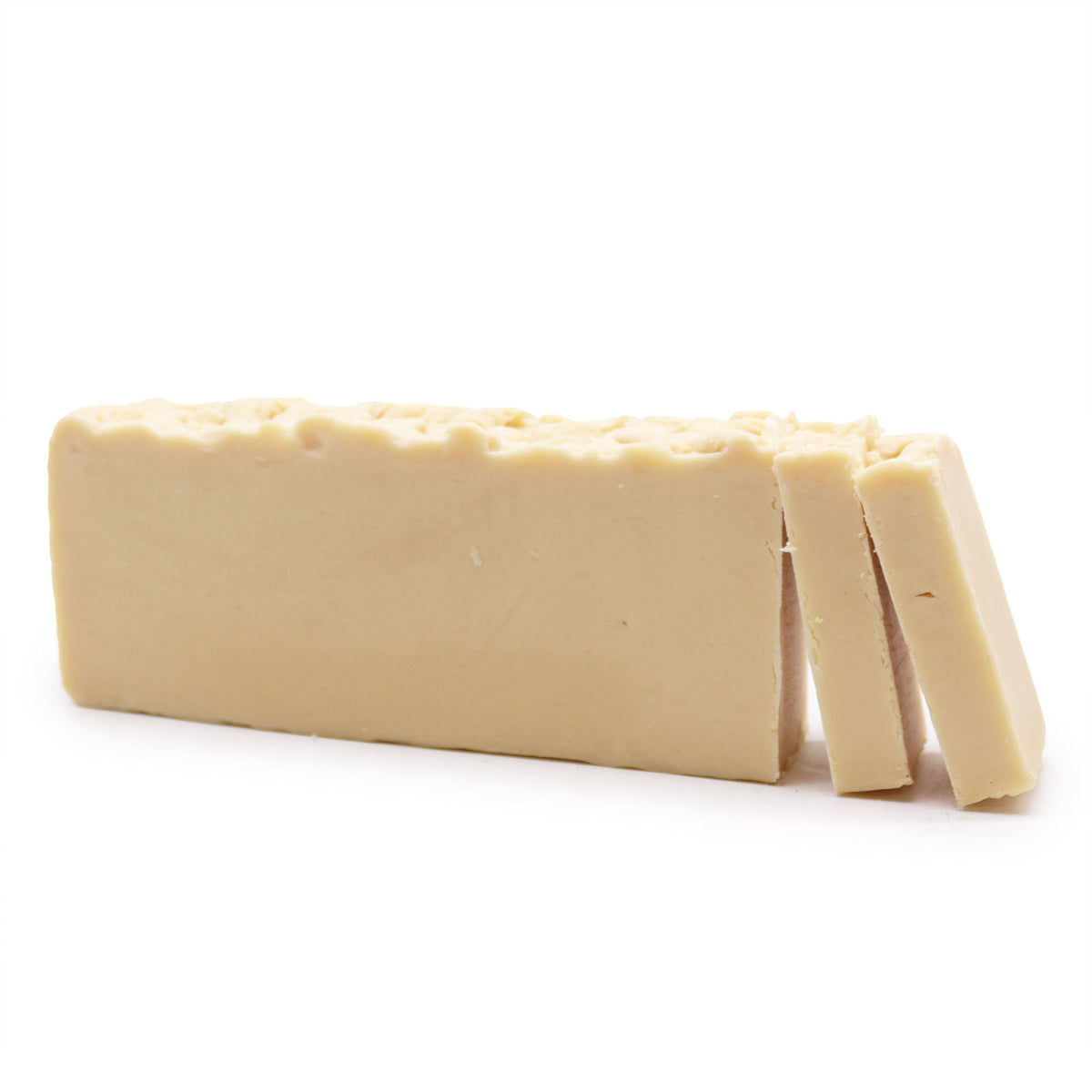Donkey Milk, Olive Oil Soap Loaf, pale cream loaf with two slices cut off, shown on white
