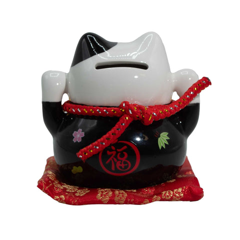 Ceramic Money Cat Bank, Black on Cushion, rear view with coin slot, red cord and gold-patterned red cushion