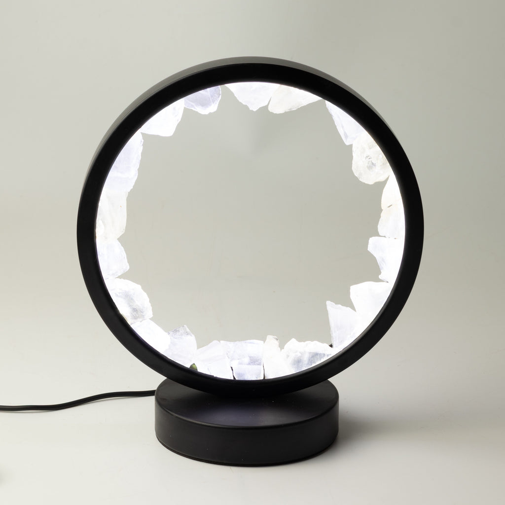 Zen Mind clear quartz halo lamp lit in its black circular frame