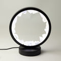 Zen Mind clear quartz halo lamp lit in its black circular frame