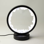 Zen Mind clear quartz halo lamp lit in its black circular frame