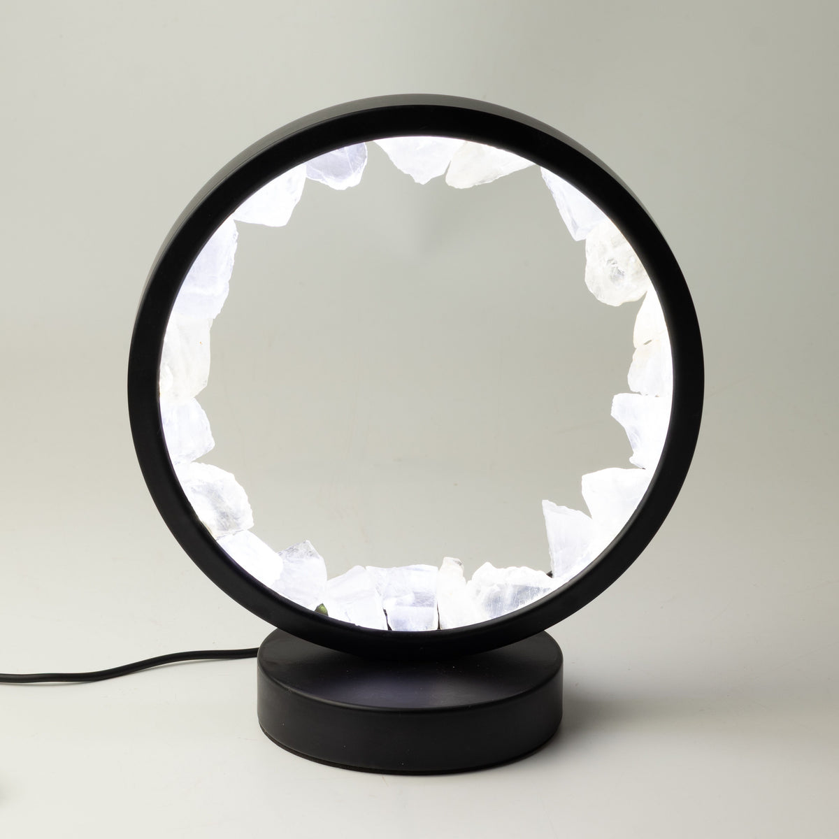 Zen Mind clear quartz halo lamp lit in its black circular frame