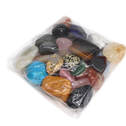 Mixed tumble stones in assorted colours shown inside a clear plastic bag