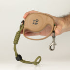Hand holding the lead casing, clip and rope wrist strap