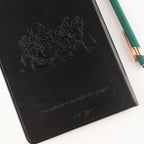 Embossed black leather-effect notebook cover with stitched edge