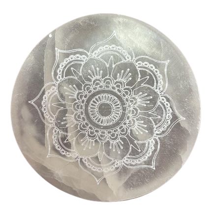Mandala charging plate shown close up on a white background, with its pale surface and etched floral design