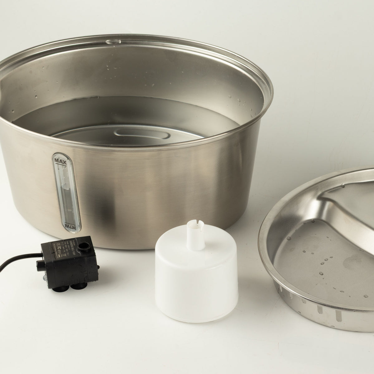 Fountain shown with its lid, pump and accessories