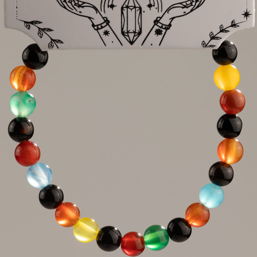 Rainbow beads arranged in a curve against the presentation card