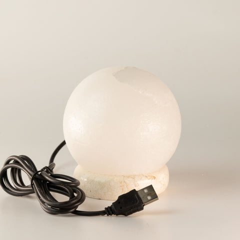 White USB ball salt lamp with coiled black cable and USB plug, shown unlit from the front