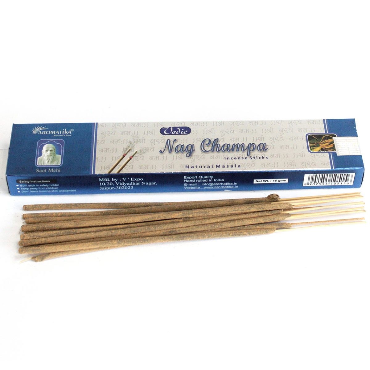 Nag Champa incense sticks laid beside their blue and white box on a white background