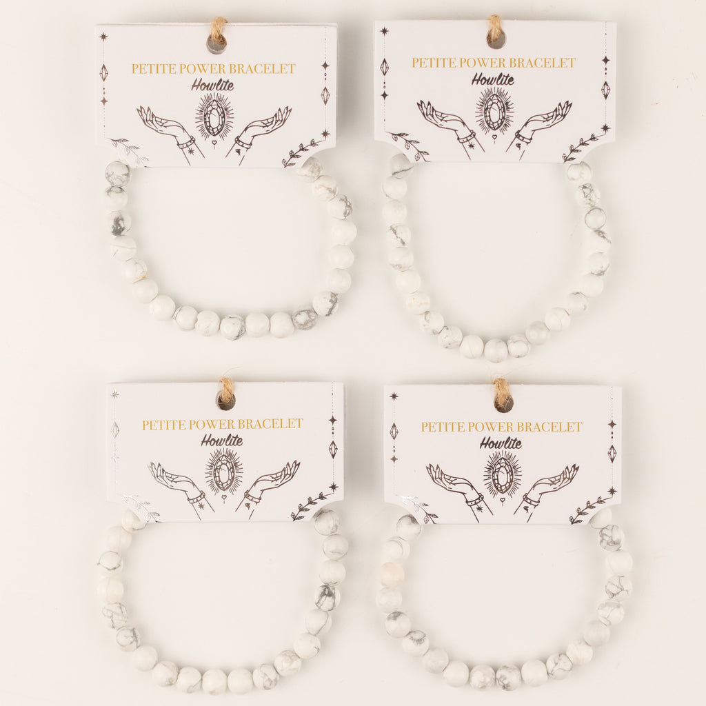 Several Howlite bracelets displayed on their illustrated cards