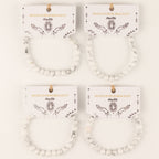 Several Howlite bracelets displayed on their illustrated cards