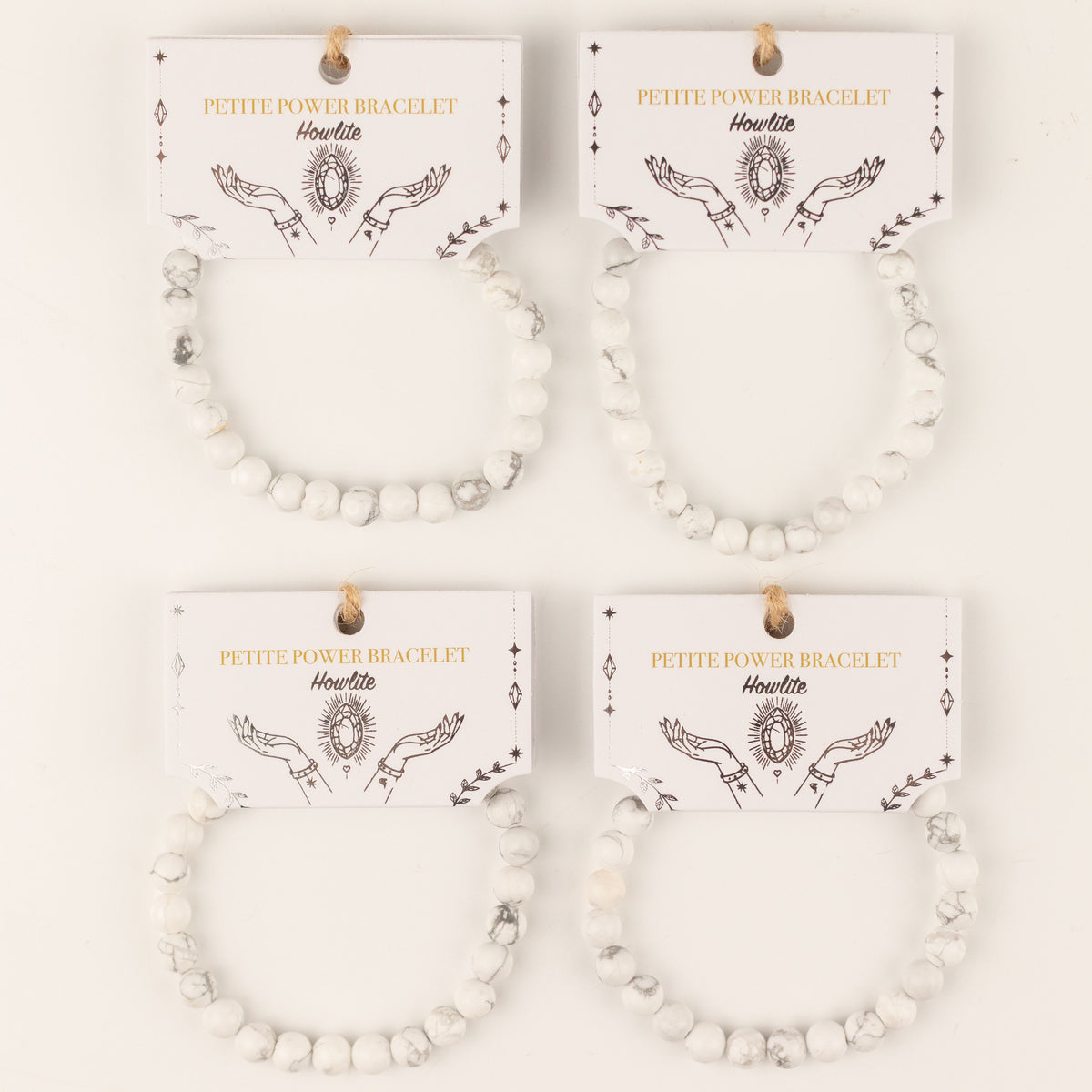 Several Howlite bracelets displayed on their illustrated cards